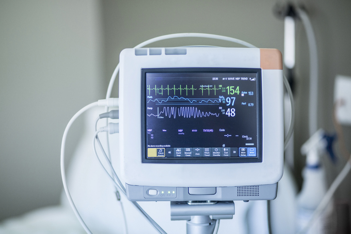 Medical vital signs monitor instrument in a hospital. This health care device displays and monitors heart rate and oxygen levels in hospital patients