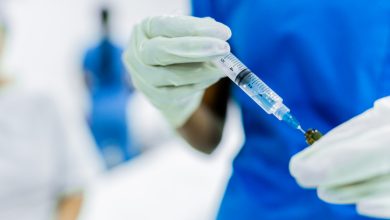 Close-up of a female nurse preparing vaccine at the hospital